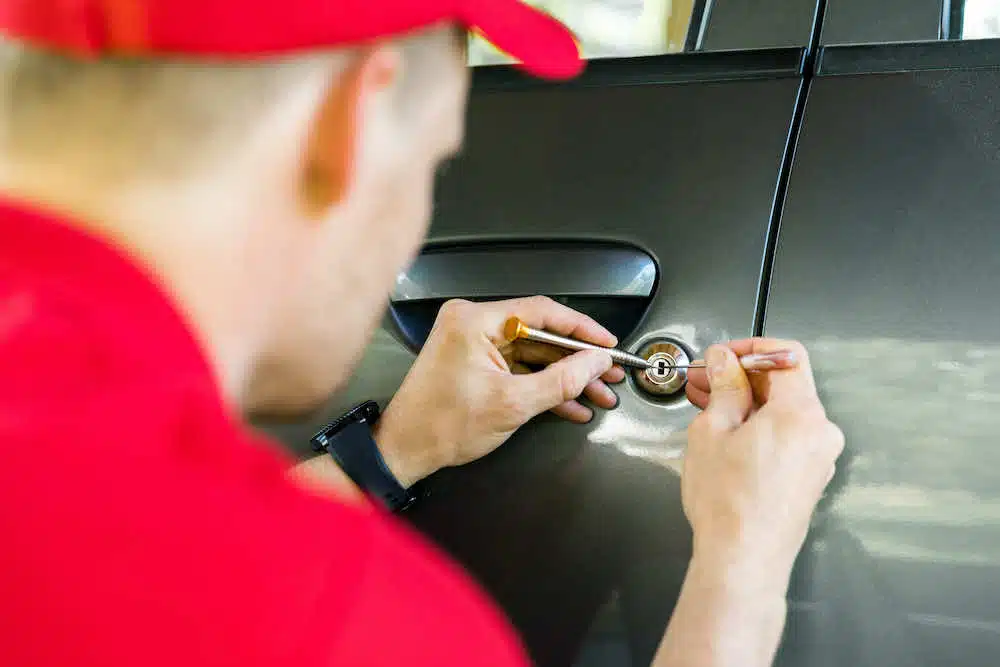 Professional locksmith working on car lockout